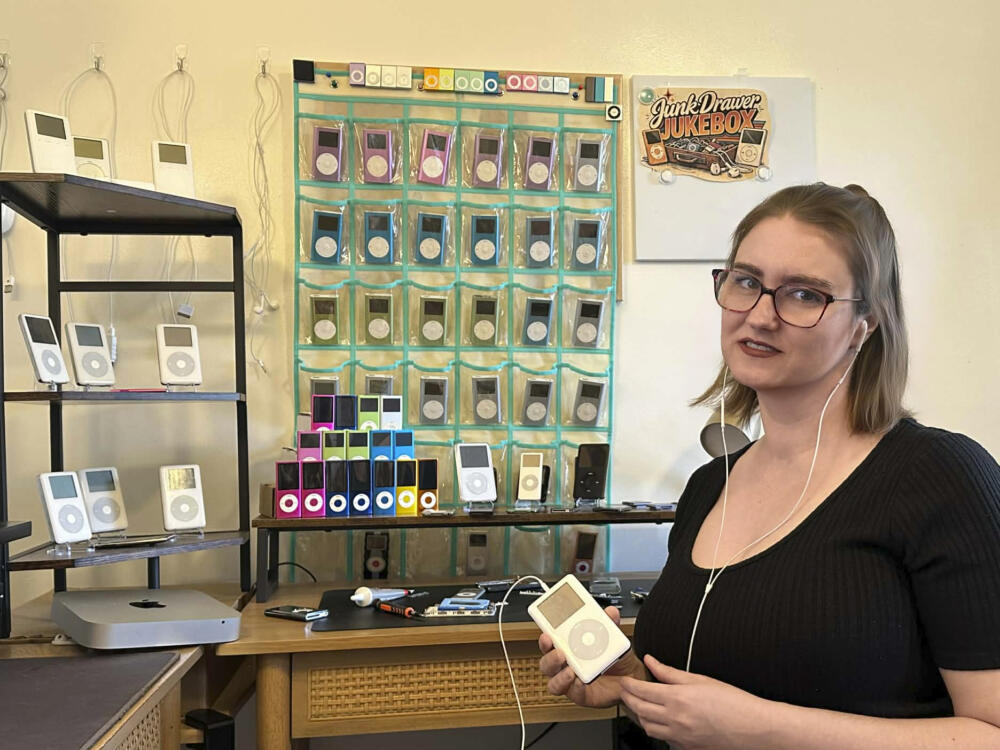 Claire Hughes stands with her collection of old iPods. (Courtesy of Claire Hughes)