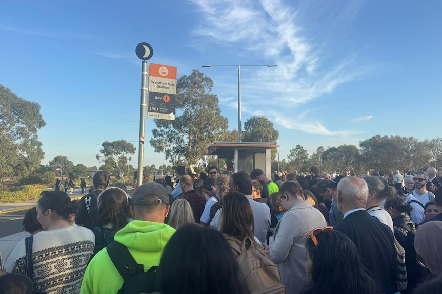 People gathered at a railway station.