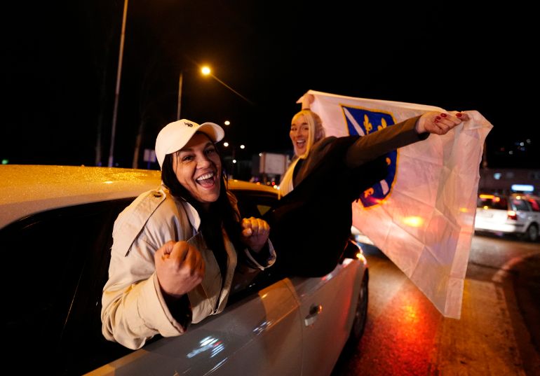 Soccer Football - FIFA World Cup - UEFA Qualifiers - Finals - Bosnia and Herzegovina v Italy - Zenica, Bosnia and Herzegovina - April 1, 2026 Bosnia and Herzegovina fans celebrate out of a car after qualifying for the FIFA World Cup outside the stadium REUTERS/Matteo Ciambelli