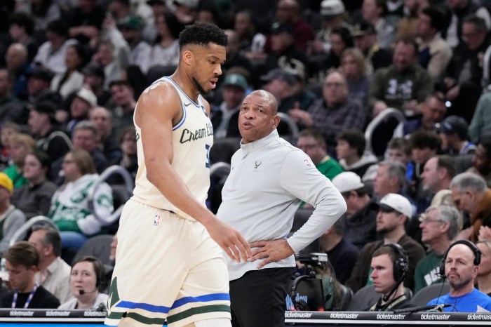 Doc Rivers talks to Giannis Antetokounmpo as he comes out of the game.
