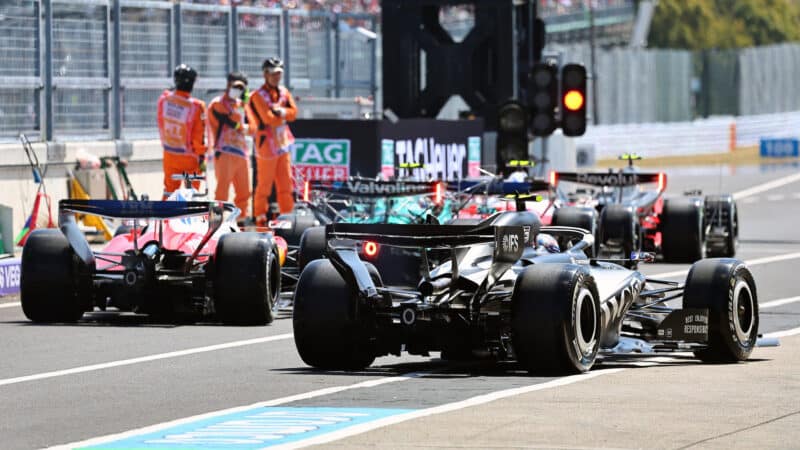 Charles Leclerc (Aston Maetin-Ferrari), Valtteri Bottas (Cadillac-Ferrari) and others in the pits before practice for the 2026 Japanese Grand Prix