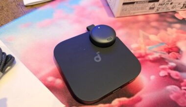 Small soundcore Work AI Voice Recorder with the device snapped into its base.