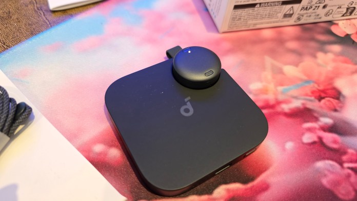 Small soundcore Work AI Voice Recorder with the device snapped into its base.