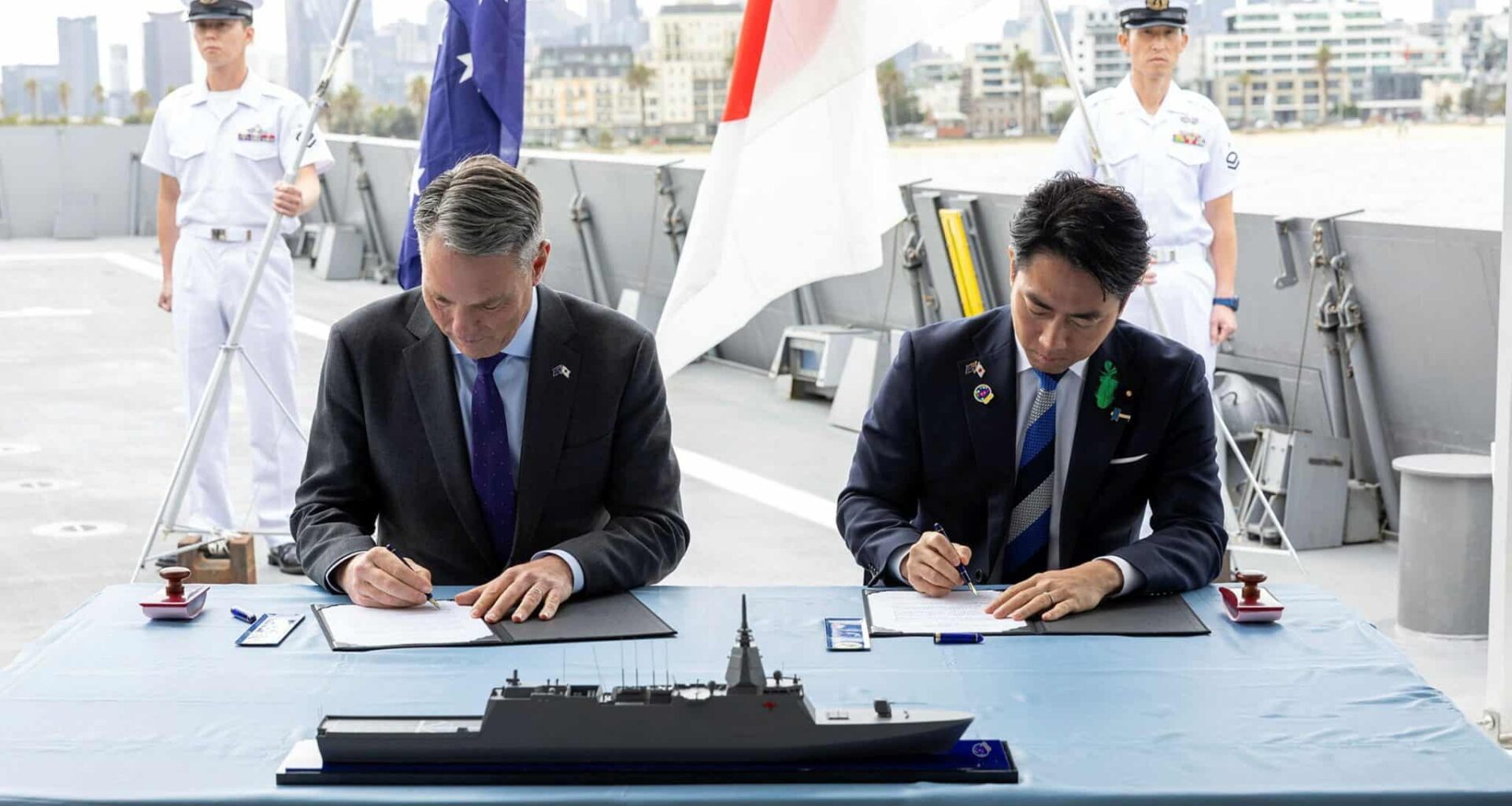 Australian and Japanese officials signing DoI on Upgraded Mogami for Australia