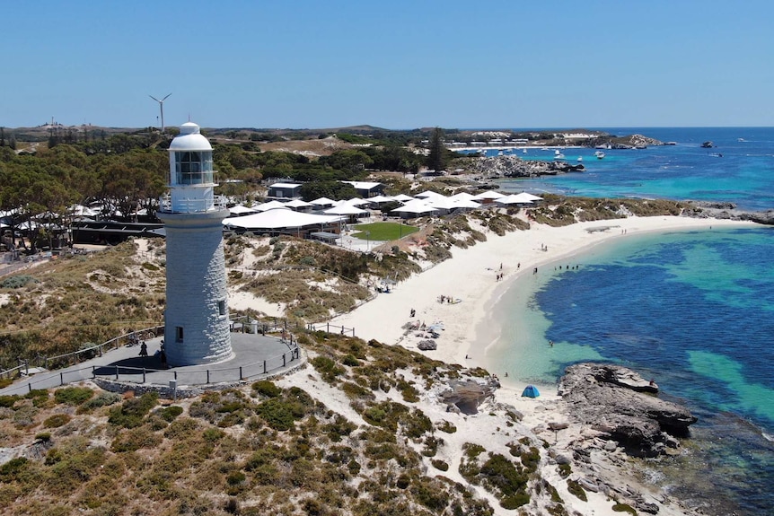 An aerial photo of the Bathurst Lighthouse in front of a series of premium tents at Rottnest Island.