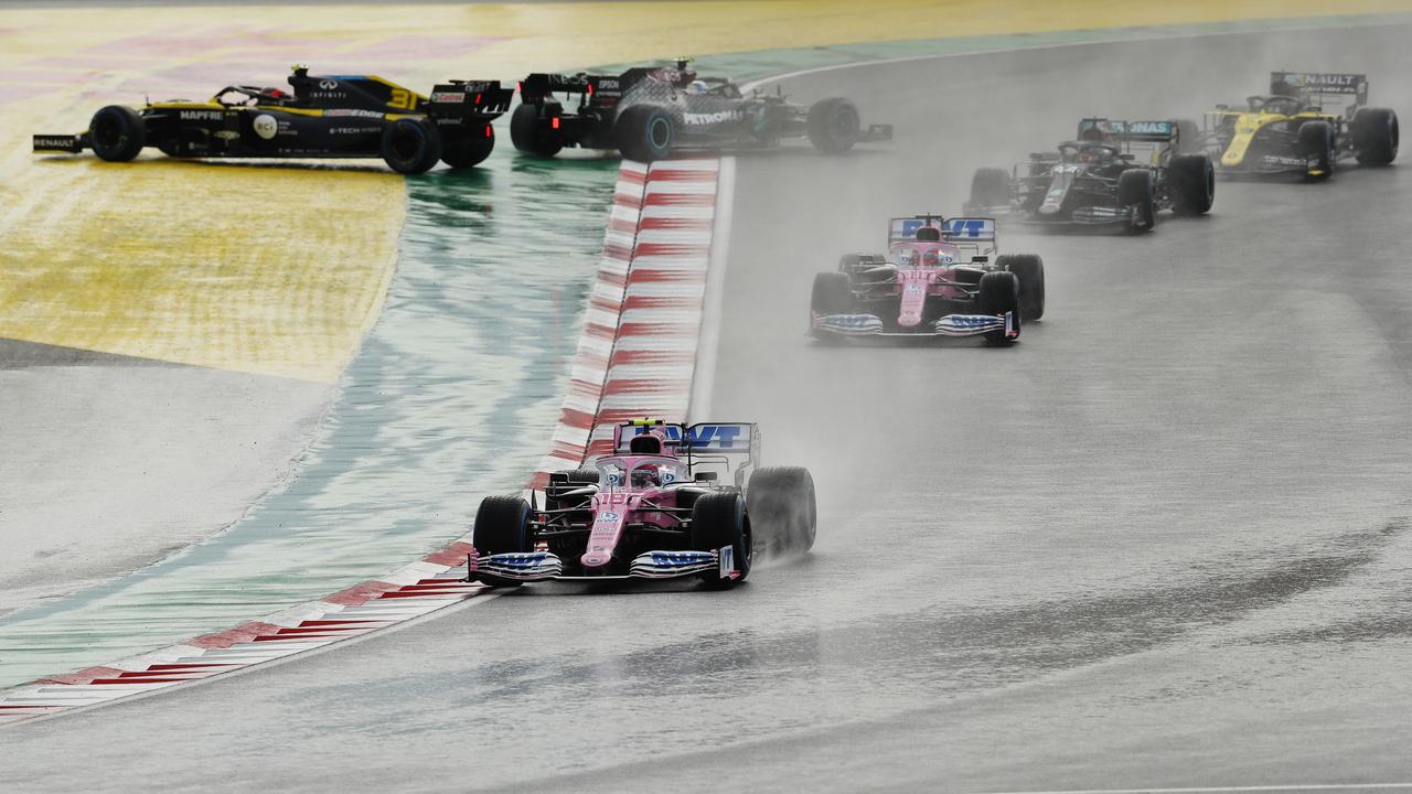 ISTANBUL, TURKEY - NOVEMBER 15: Lance Stroll of Canada driving the (18) Racing Point RP20 Mercedes leads Sergio Perez of Mexico driving the (11) Racing Point RP20 Mercedes and the rest of the field at the start during the F1 Grand Prix of Turkey at Intercity Istanbul Park on November 15, 2020 in Istanbul, Turkey. (Photo by Murad Sezer - Pool/Getty Images)