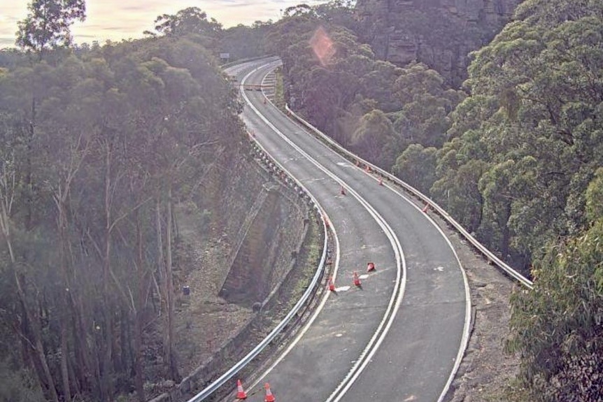 A closed road through a mountain with no traffic on it.