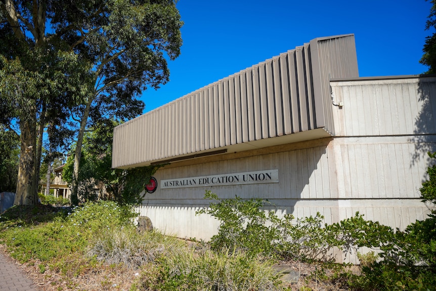 A concrete building with a metal roof