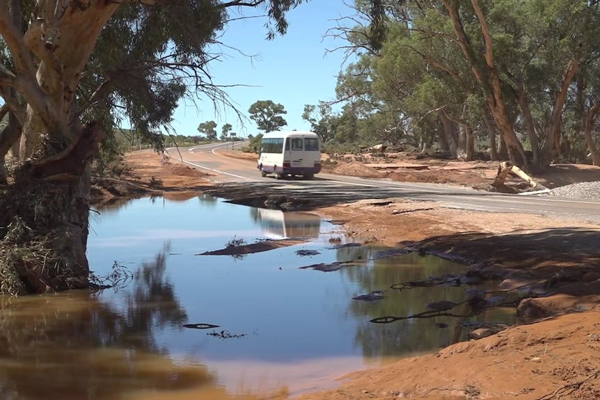 A large pool of water next to a bitumen road in Hawker, outback South Australia