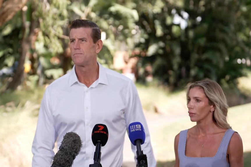 ben roberts smith  talks to the media with his partner sarah standing next to him