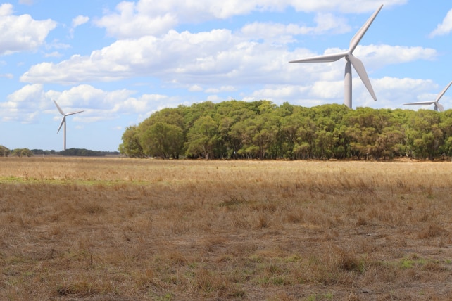 A digitally-generated image of wind turbines in a country area.