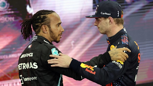 Max Verstappen (NDL) Red Bull Racing, RB16B, Honda engine and Lewis Hamilton (GBR) Mercedes AMG F1 Team after winning the final race during the Grand Prix Formula One of Abu Dhabi at Yas Marina Circuit on December 12, 2021 in Abu Dhabi, United Arab Emirates. (Photo by Irwen Song ATPImages/Getty Images)