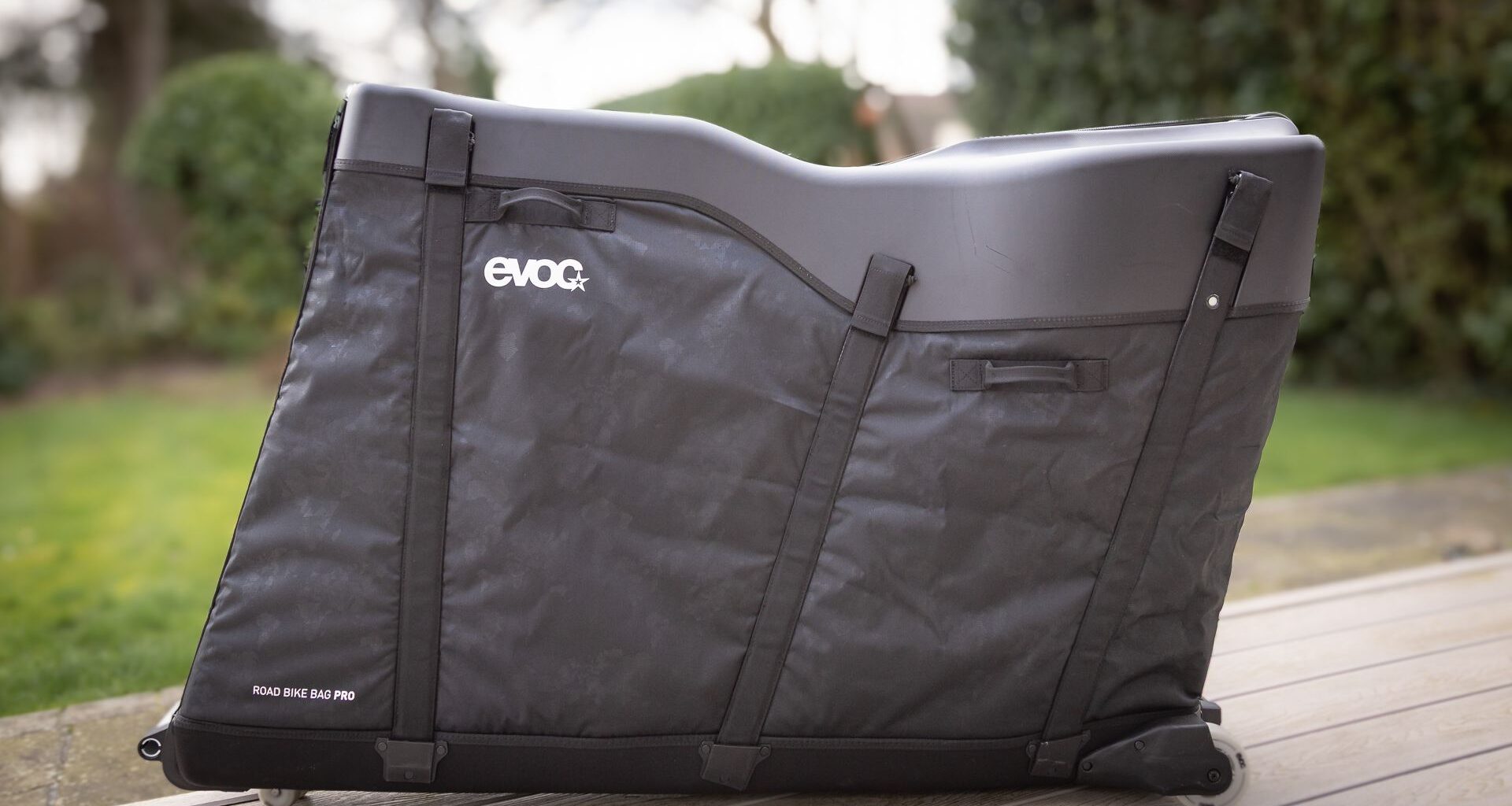 A black bike box standing in a garden