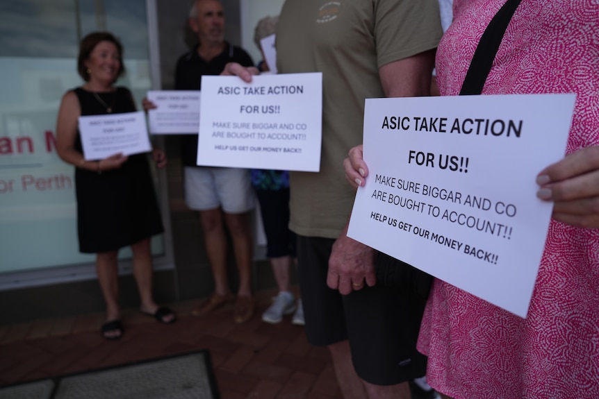 people holding up placards