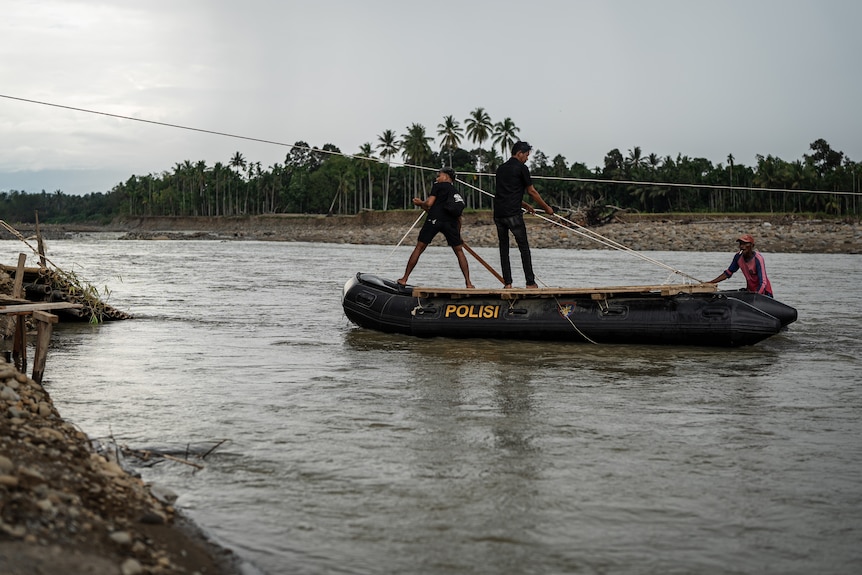 Local police navigating the floodwaters during assessment and rescue missions.