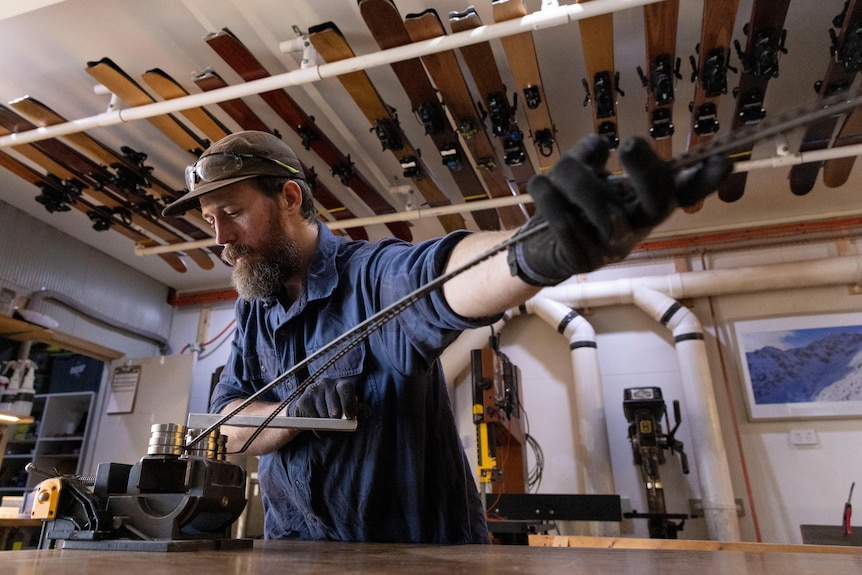 A man manufacturing bending metal in a workshop.