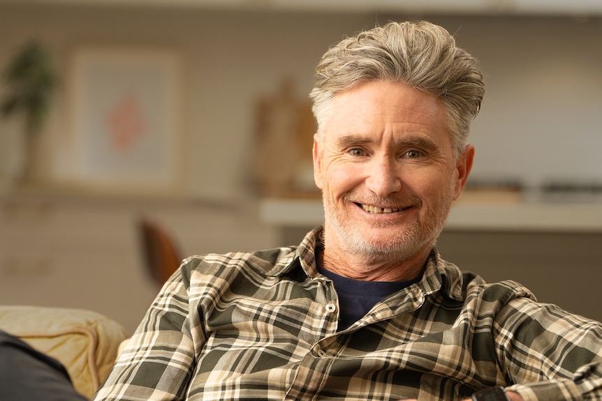 Dave Hughes seated, shoulders up, smiling