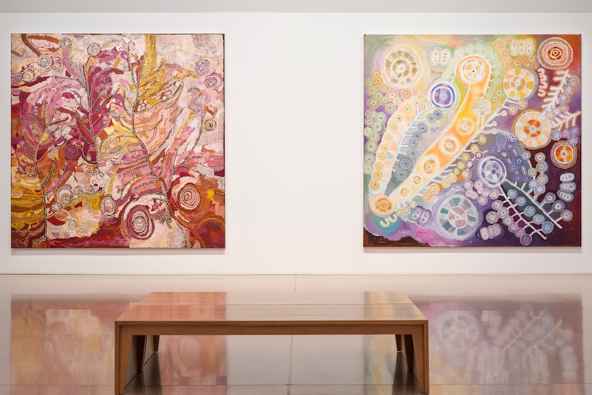 Two artworks on a wall in a gallery.