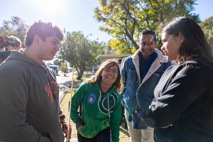 Demeil, Olivia, Imogen and Jeremy Fernandez talk in a circle
