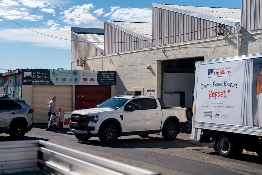 People dropping donations at an op shop warehouse