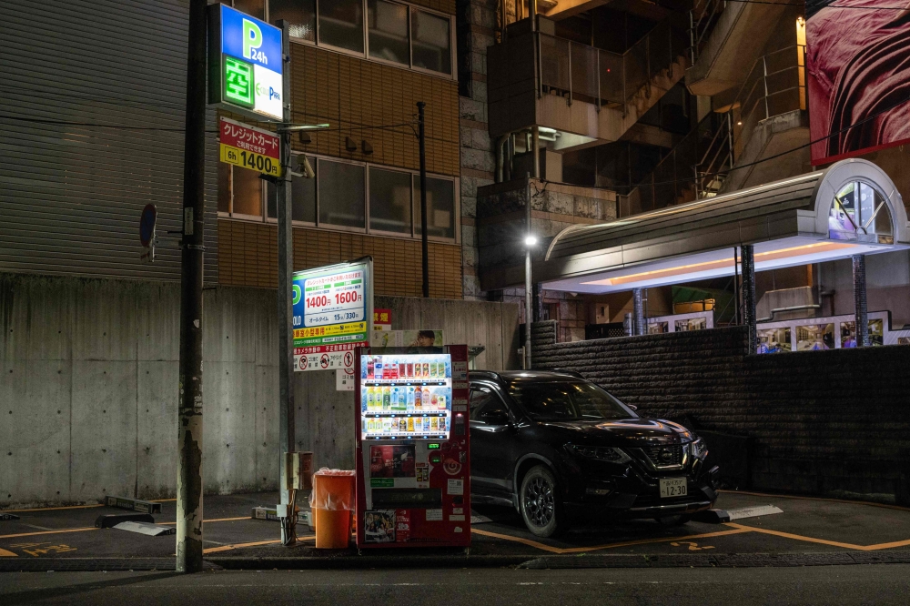 A vending machine is setup in a small parking lot on a side street in Tokyo’s Shinjuku on April 13, 2026. — AFP pic