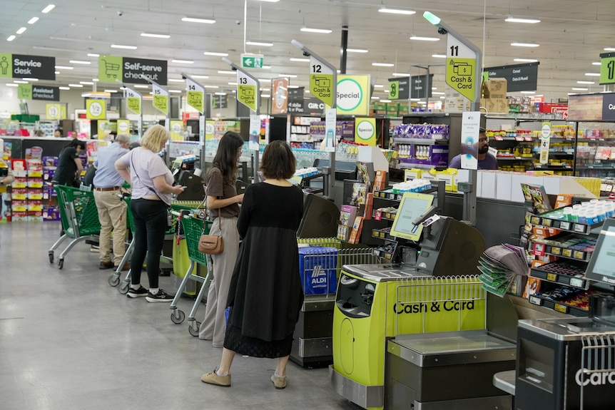 Shoppers at the self check-out at a Woolworths store, generic.