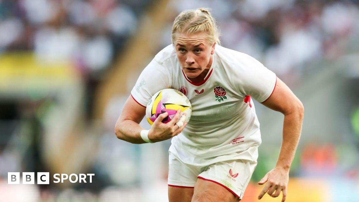 Alex Matthews runs with her body bent slightly forward and a rugby ball tucked to her chest under her right arm as she looks ahead during a World Cup match for England in 2025