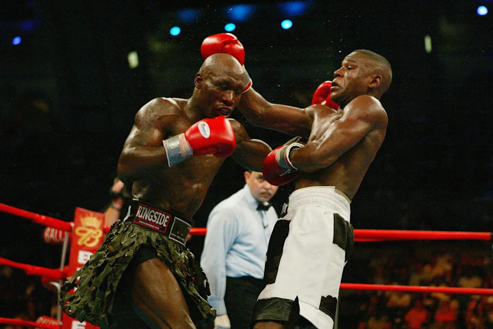 ATLANTIC CITY, NJ - MAY 22:  Demarcus Corley (green) punches Floyd Mayweather during their WBC Super Lightweight eliminator bout on May 22, 2004 at Boardwalk Hall in Atlantic City, New Jersey.  Floyd Mayweather won by decision.  (Photo by Al Bello/Getty Images)