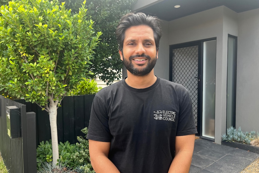 A picture of Aman Gaur smiling at the camera taken from the waist up