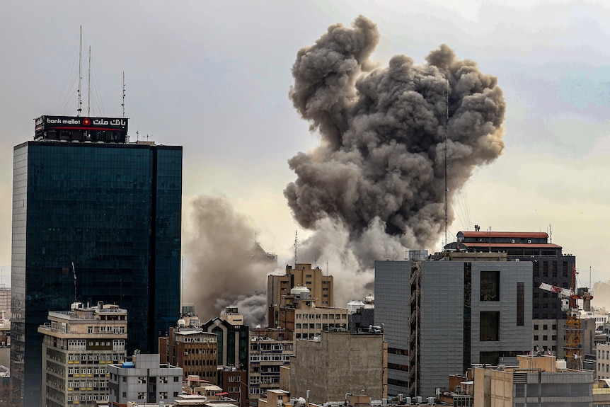 A general view of Tehran with smoke visible in the distance 