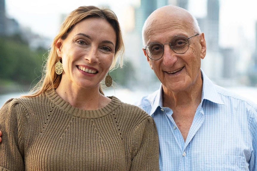 Claudia Karvan and David Malouf standing together with a city and water behind them.