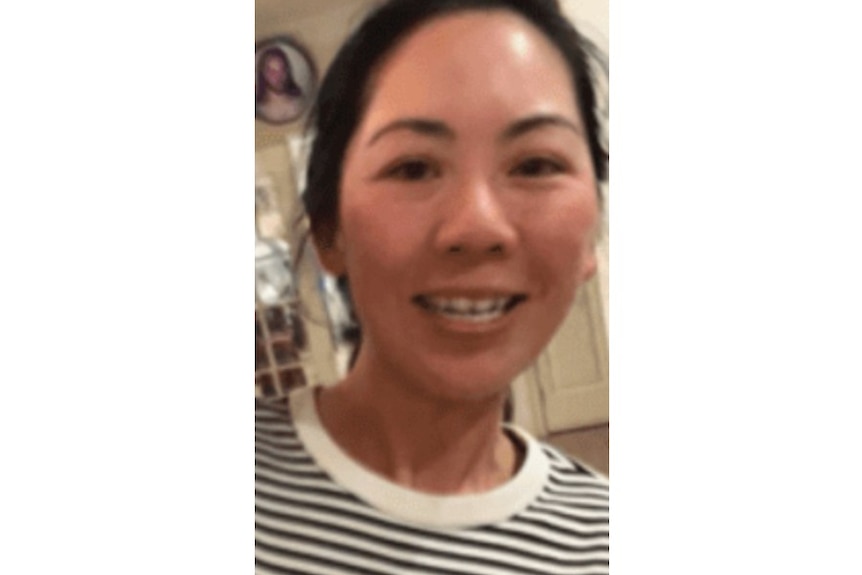 woman with black hair smiling at camera