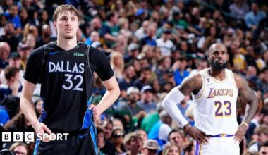 Cooper Flagg and LeBron James stand next to each other on court
