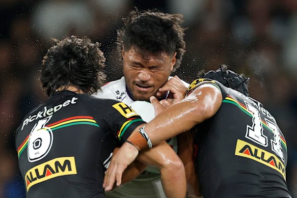 Stefano Utoikamanu gets crunched by the Penrith defence.