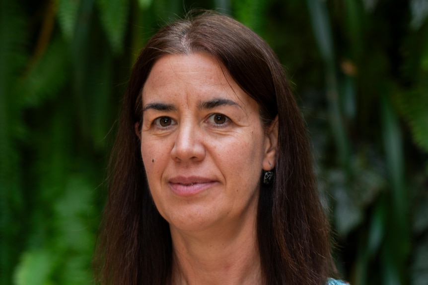 A headshot of a dark haired woman