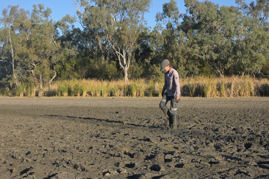 Person in boots walks through the mud.