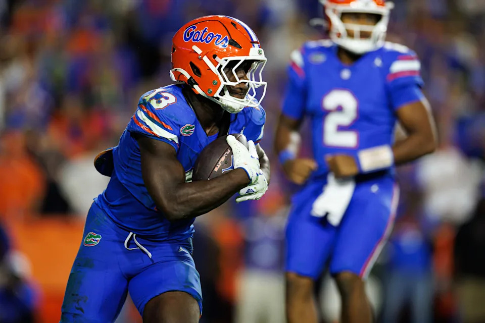 Nov 29, 2025; Gainesville, Florida, USA; Florida Gators running back Jadan Baugh (13) rushes with the ball against the Florida State Seminoles during the second half at Ben Hill Griffin Stadium. Mandatory Credit: Matt Pendleton-Imagn Images