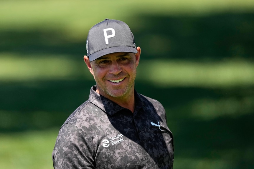 Gary Woodland smiles on the driving range before a practice round ahead of the Masters, smiling.