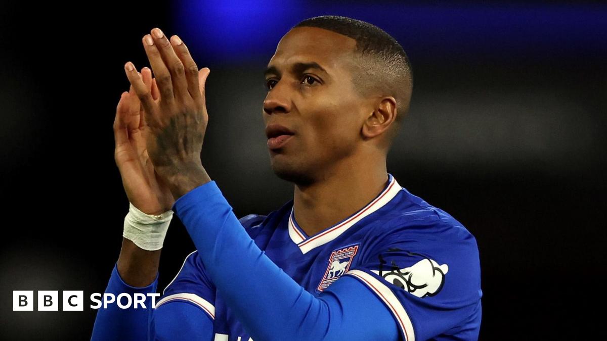Former England defender Ashley Young in a blue Ipswich Town shirt, clapping his hands