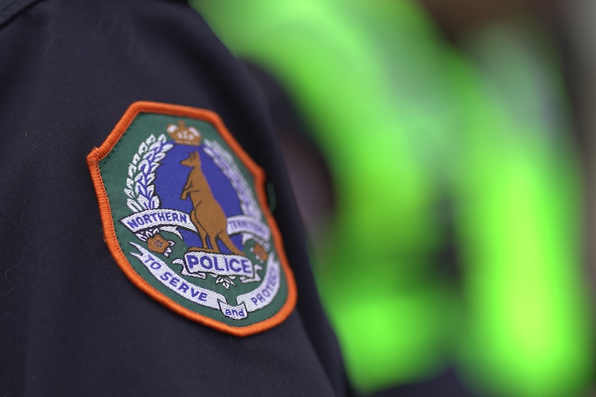 A patch of the NT police force emblem on an unidentified officer's uniform