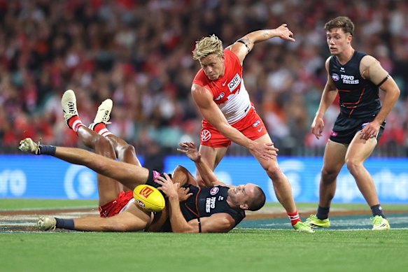 Harry Himmelberg is tackled by Joel Amartey as Isaac Heeney lends his support.