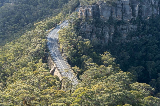 road winding between cliffs and trees