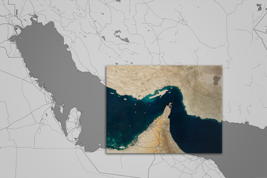 A satellite image of the Persian Gulf and the Strait of Hormuz imposed over a map.