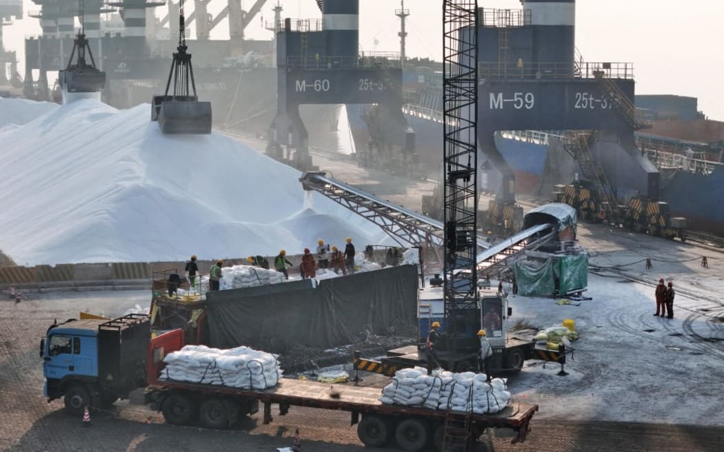 Middle East war causes fertiliser shortage in China, in spring: Workers bag bulk fertilizer at Yantai Port in east China's Shandong Province, 26 March 2026.