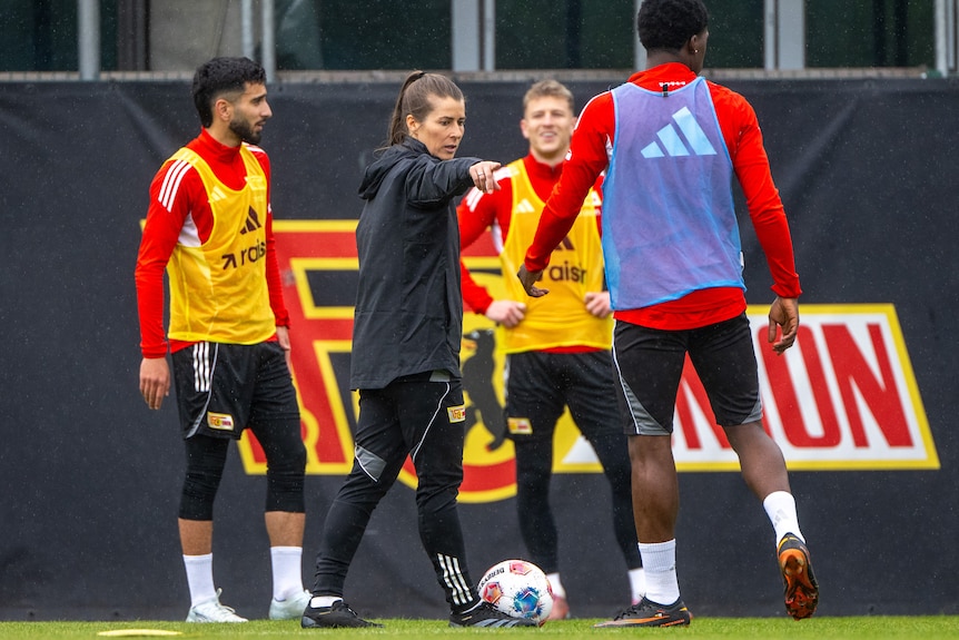 Marie Louise Eta points to her players