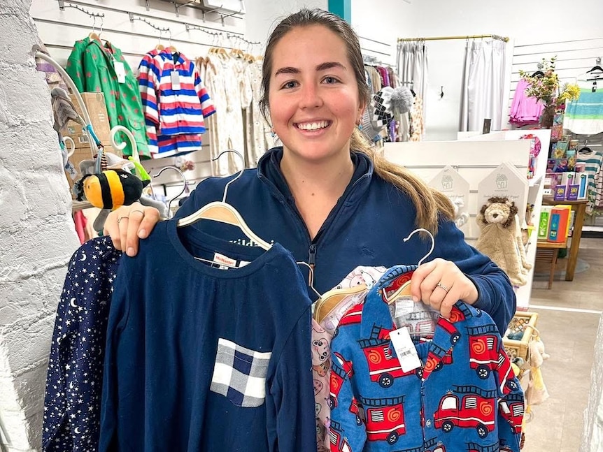 a woman holds pyjamas