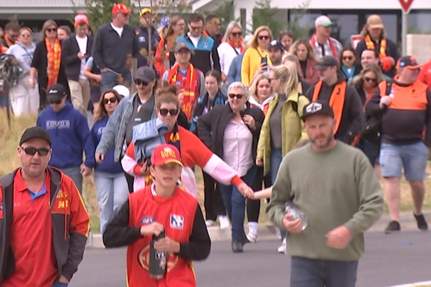 Football fans walk to game at Mount Barker Oval.