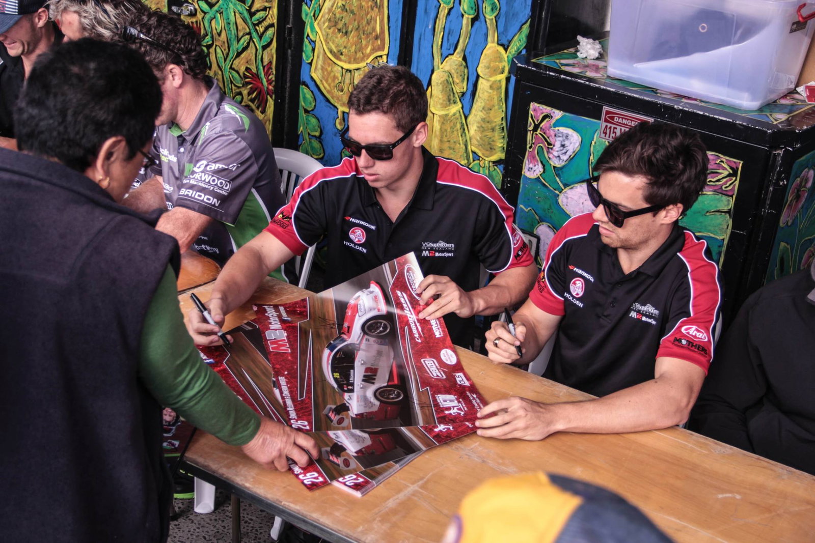 Cameron Waters with Simon McLennan during a V8 SuperTourers signing session.