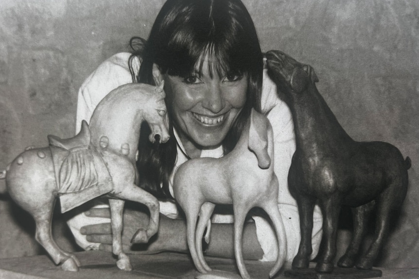 black and white photo of artist with horse sculptors