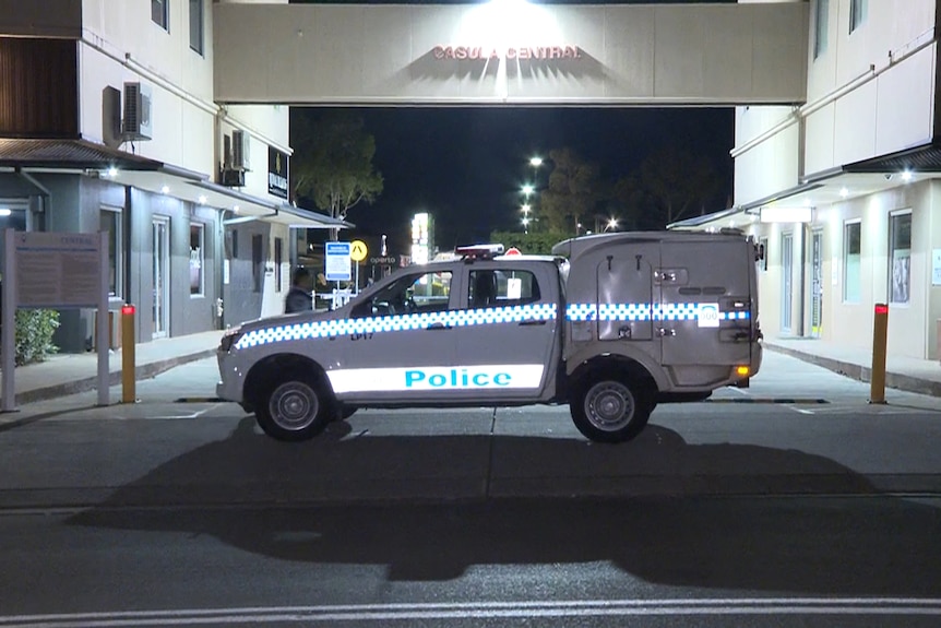 A police car and tape outside a shopping centre.